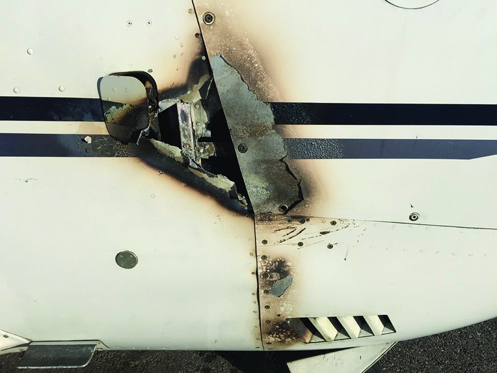 burned hole in aircraft fuselage